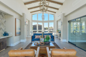 Interior Clubhouse, Contemporary rustic decor, leather lounge chairs, high ceilings, view of pool area, abstract art on the walls, wood floors, neutral toned walls.